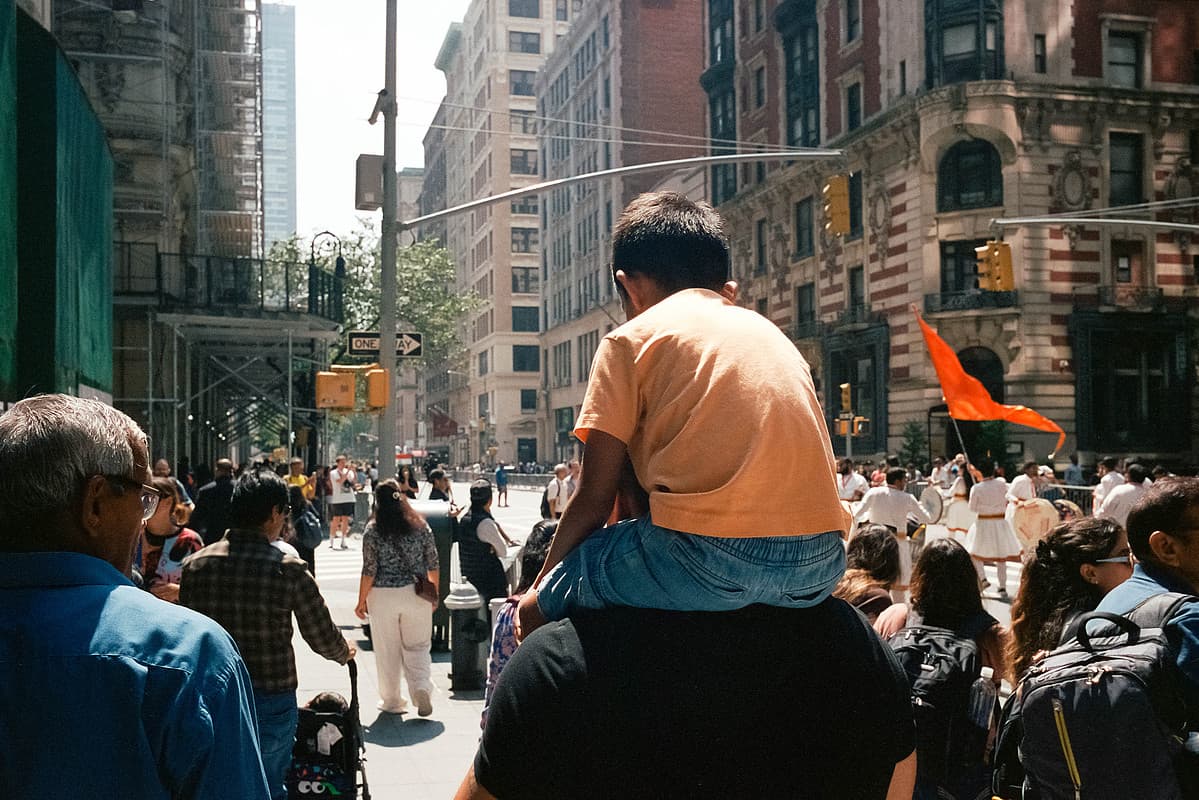 Kid on shoulders at the parade